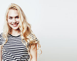 Image showing young pretty teenage hipster girl posing emotional happy smiling on white background, lifestyle people concept 