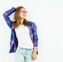 Image showing young pretty teenage hipster girl posing emotional happy smiling on white background, lifestyle people concept 