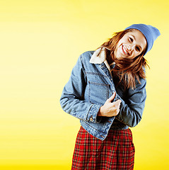 Image showing lifestyle people concept: pretty young school teenage girl having fun happy smiling on yellow background 