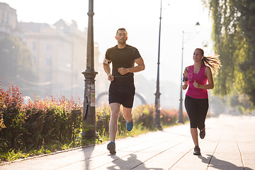 Image showing young couple jogging  in the city