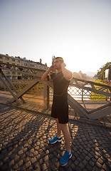 Image showing portrait of a jogging man at sunny morning