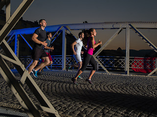 Image showing young people jogging across the bridge