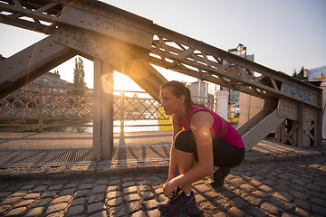 Image showing woman tying running shoes laces