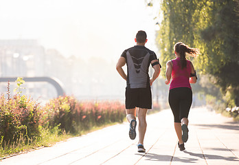 Image showing young couple jogging  in the city