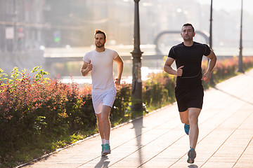 Image showing group of young people jogging in the city