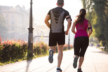 Image showing young couple jogging  in the city