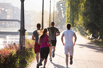 Image showing group of young people jogging in the city