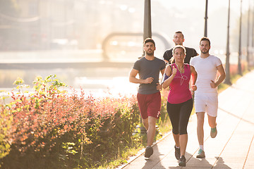 Image showing group of young people jogging in the city