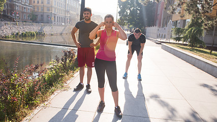 Image showing group of young people jogging in the city