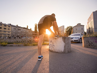 Image showing man tying running shoes laces