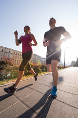 Image showing young couple jogging  in the city