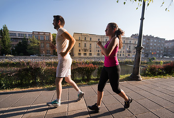 Image showing young couple jogging  in the city