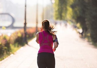 Image showing woman jogging at sunny morning