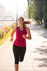 Image showing woman jogging at sunny morning