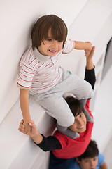 Image showing young boys posing line up piggyback top view