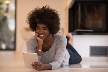 Image showing black women using tablet computer on the floor