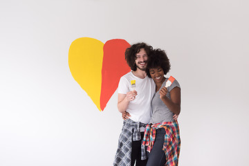 Image showing couple with painted heart on wall