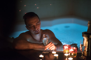 Image showing man relaxing in the jacuzzi