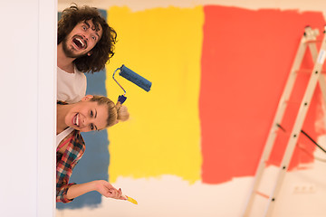 Image showing portrait of a couple painting interior wall