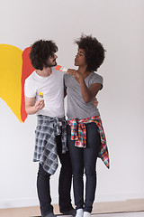 Image showing couple with painted heart on wall