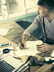 Image showing Architect working on drawing table in office