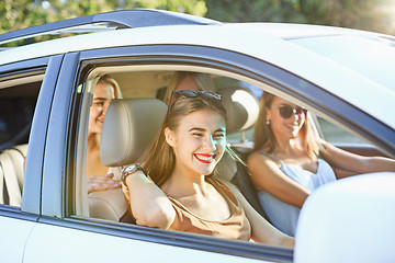 Image showing The young women in the car smiling