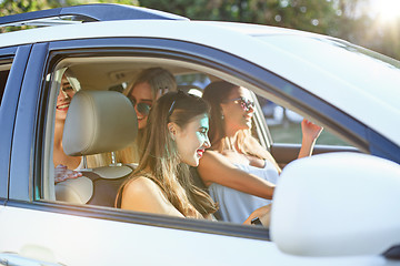 Image showing The young women in the car smiling