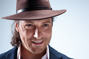 Image showing Young man portrait with hat on gray studio background.