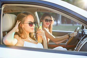 Image showing The young women in the car smiling