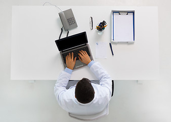 Image showing doctor typing on laptop at clinic