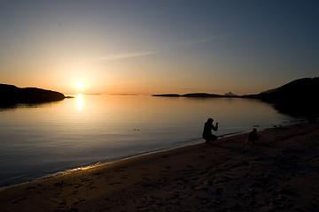 Image showing Mother photographing her child at the beach