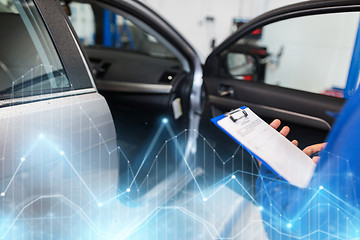 Image showing auto mechanic man with clipboard at car workshop