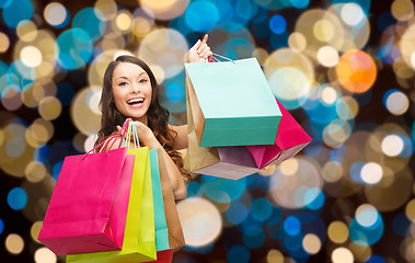 Image showing happy woman with colorful shopping bags