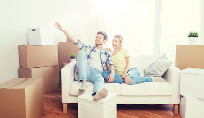 Image showing couple with boxes moving to new home and dreaming