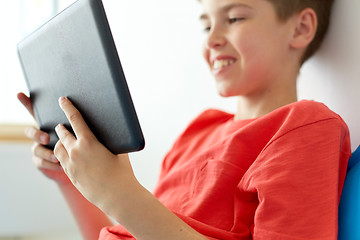 Image showing close up of boy with tablet pc computer at home