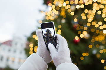 Image showing hands with smartphone photographing christmas tree