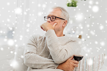 Image showing senior man drinking red wine from glass at home