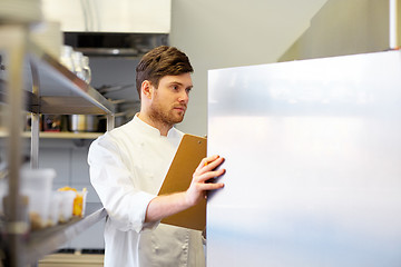 Image showing chef with clipboard doing inventory at kitchen