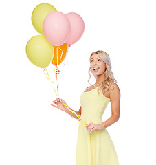 Image showing happy woman in dress with helium air balloons