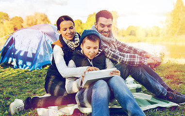 Image showing happy family with tablet pc and tent at camp site