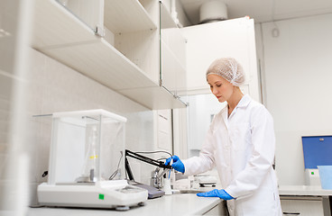 Image showing scientist with flask making test at laboratory