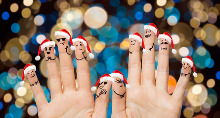 Image showing hands and fingers in santa hats at christmas