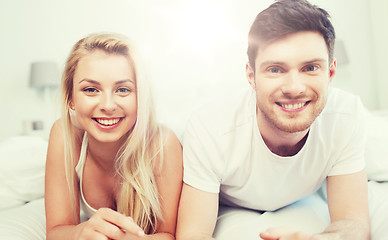 Image showing happy couple lying in bed at home