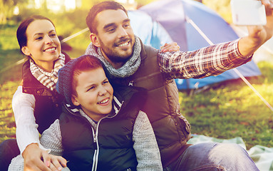 Image showing family with smartphone taking selfie at campsite