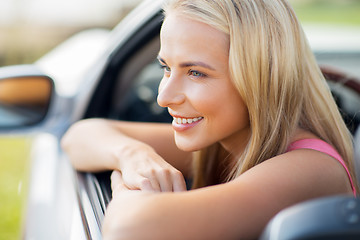 Image showing close up of happy young woman in convertible car