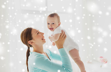 Image showing happy young mother with little baby at home