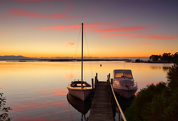 Image showing Boats moored to jetty at sunrise