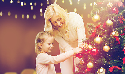 Image showing mother and daughter decorating christmas tree