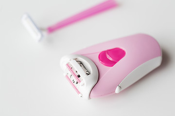 Image showing epilator and safety razor on white background