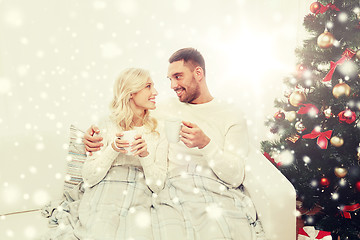 Image showing happy couple at home with christmas tree